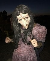 Creepy Lady Wearing a Mask with Very Long Nose and Old Fashion Dress